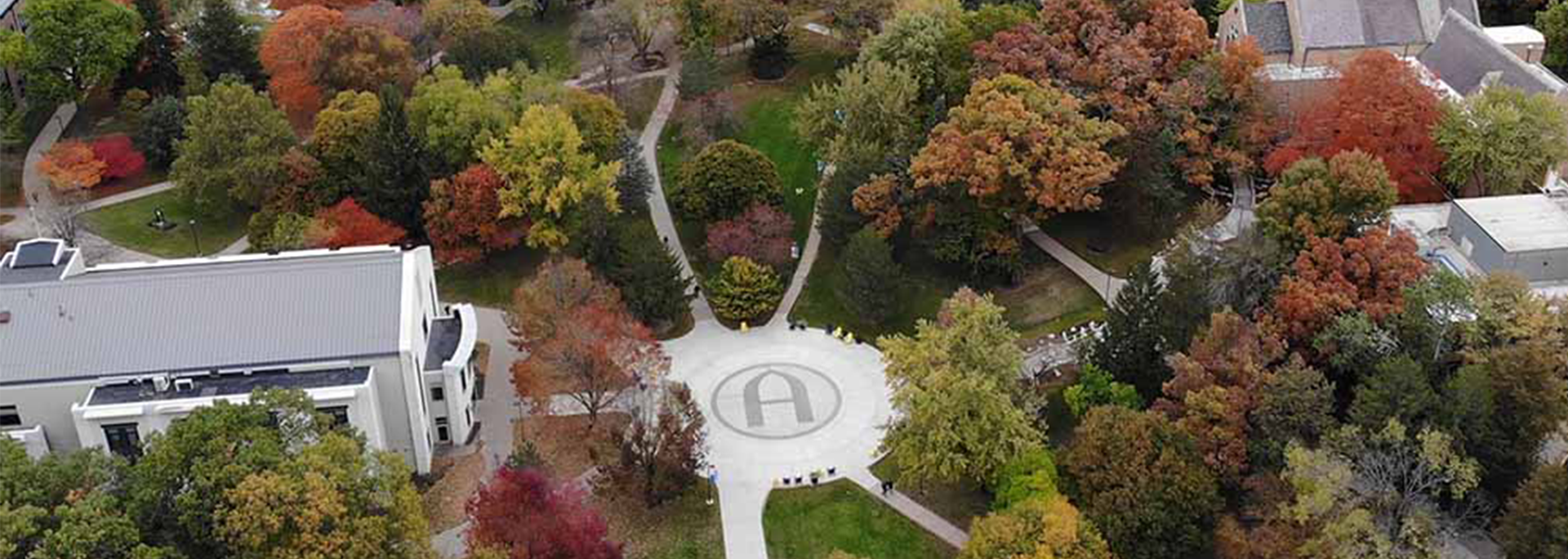 Picture of Augustana College's Lower Quad area taken in autumn with the newly-constructed Augustana A located at the junction of all sidewalks. Pictured buildings include the Olin Center for Educational Technology, Fryxell Geology Museum, and Founders Hall.